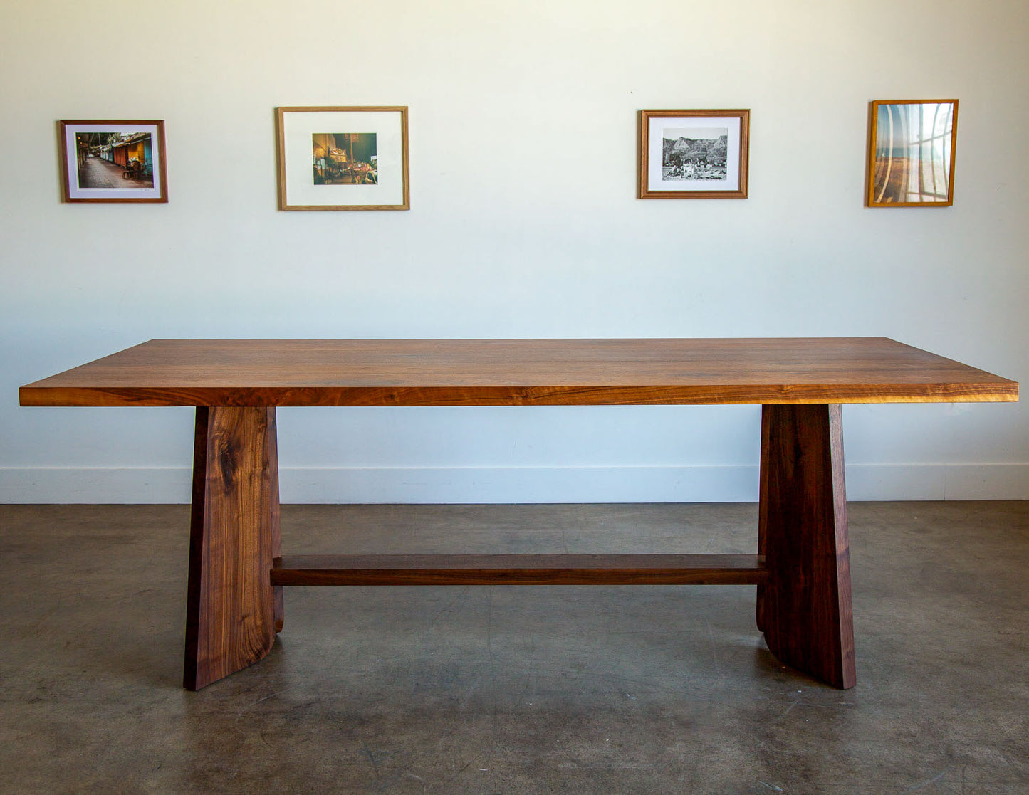 A hand-built Snyder DePass Temple Dining Table, crafted from solid Walnut, shown in a studio space to highlight its clean, contemporary design and subtle Japanese aesthetic.