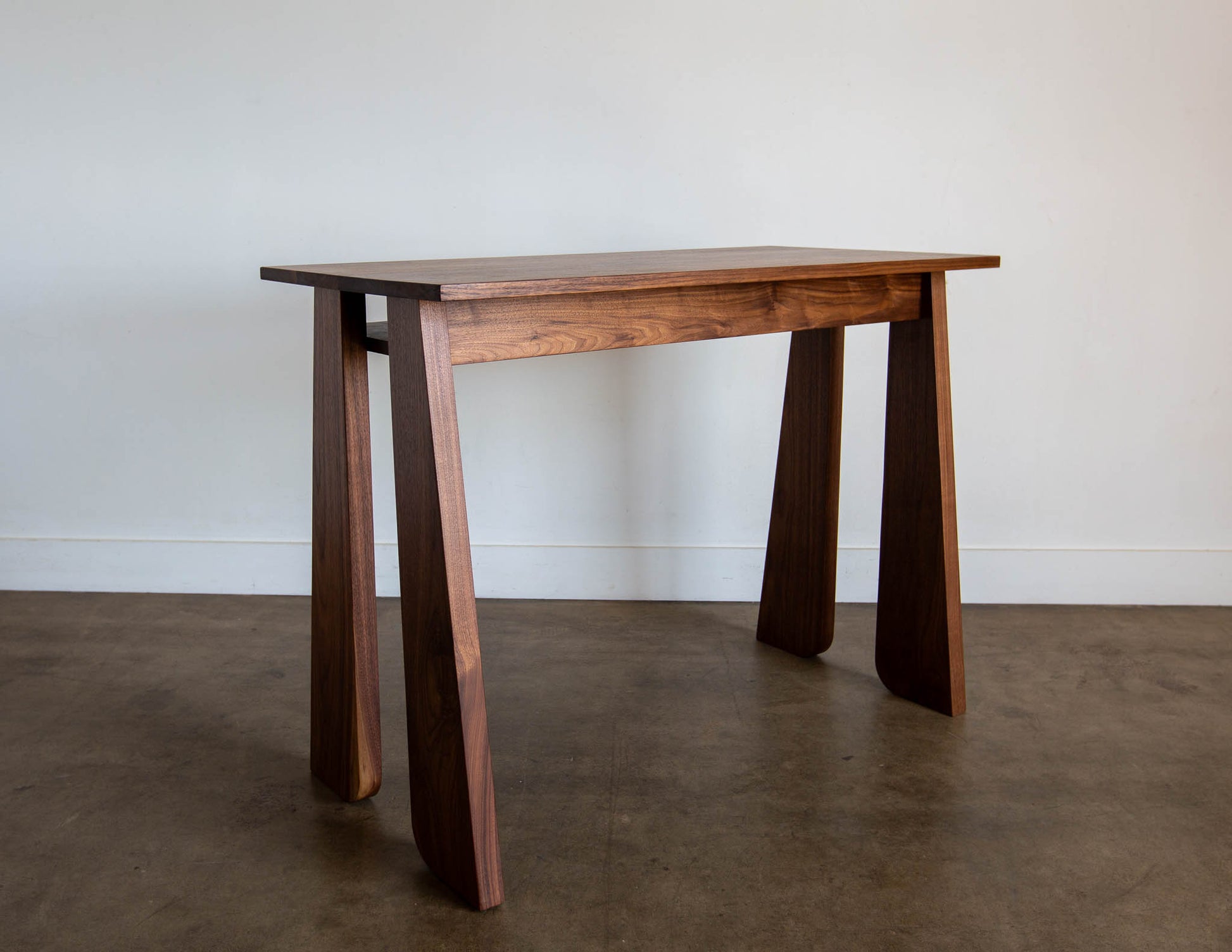A back view of the hand-built Snyder DePass Walnut Temple Desk, highlighting the seamless joinery, clean lines, and the elegant, minimalist design that makes it a beautiful piece from every angle.